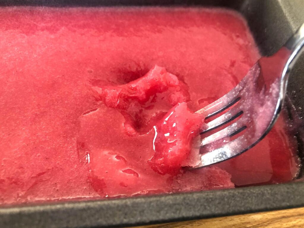 Sorbet after 1 hour in the freezer - showing the crystals forming and how to break them up with a fork.