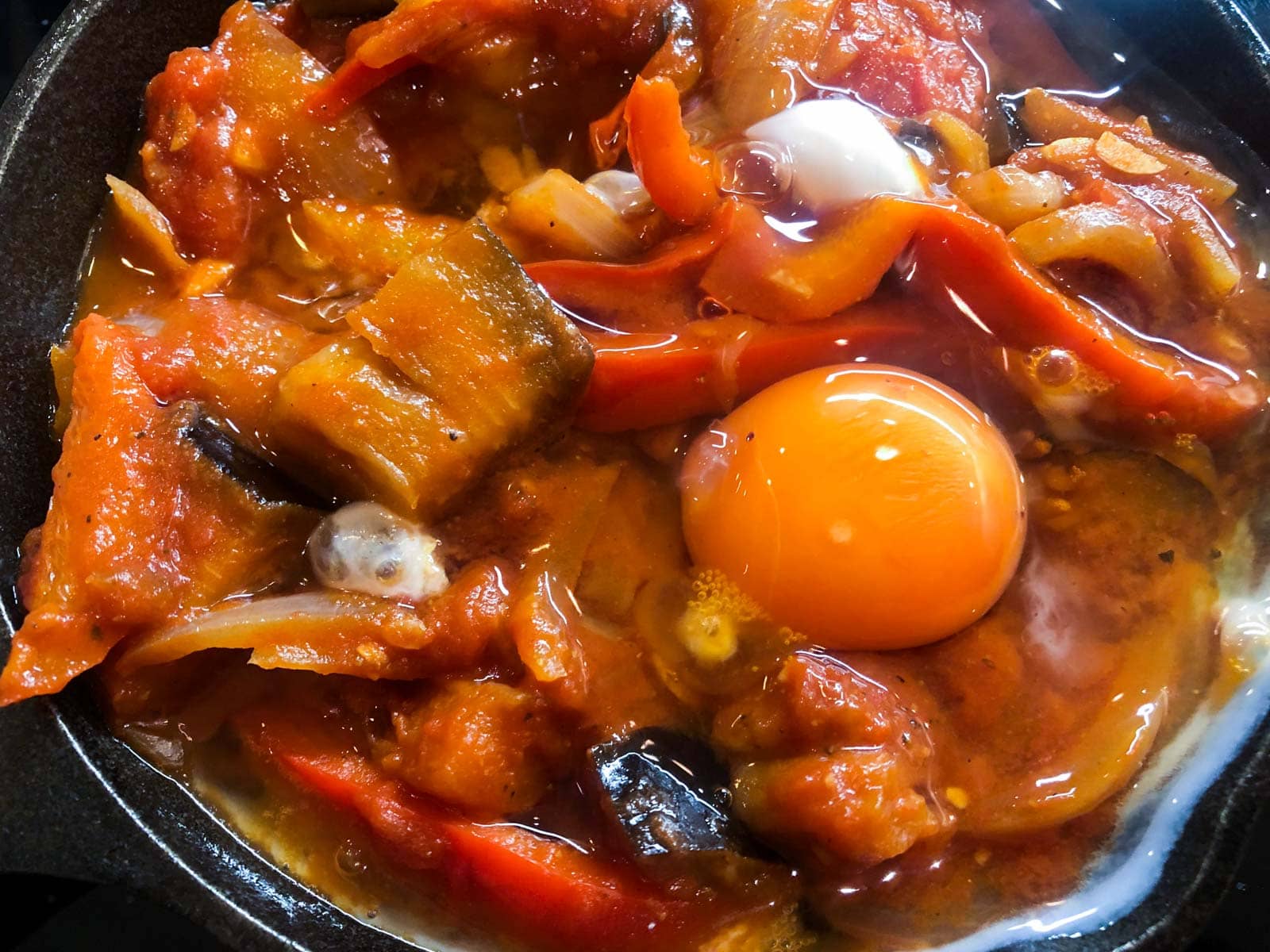 Eggs added to cooked spicy vegetables to bake for a perfect brunch dish.