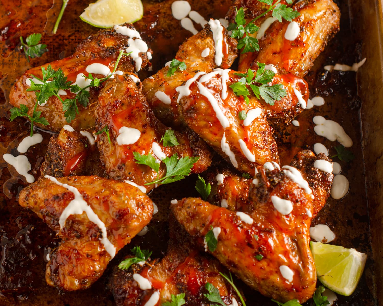 Spicy oven baked chicken wings served with a creamy lime sured cream, hot sauce, coriander and fresh limes.