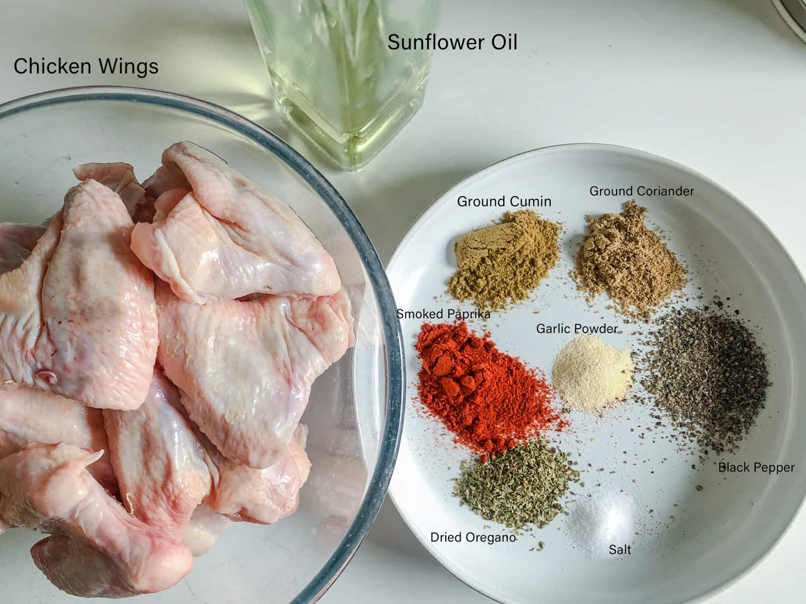 Ingredients on a marble surface to make spicy chicken wings.