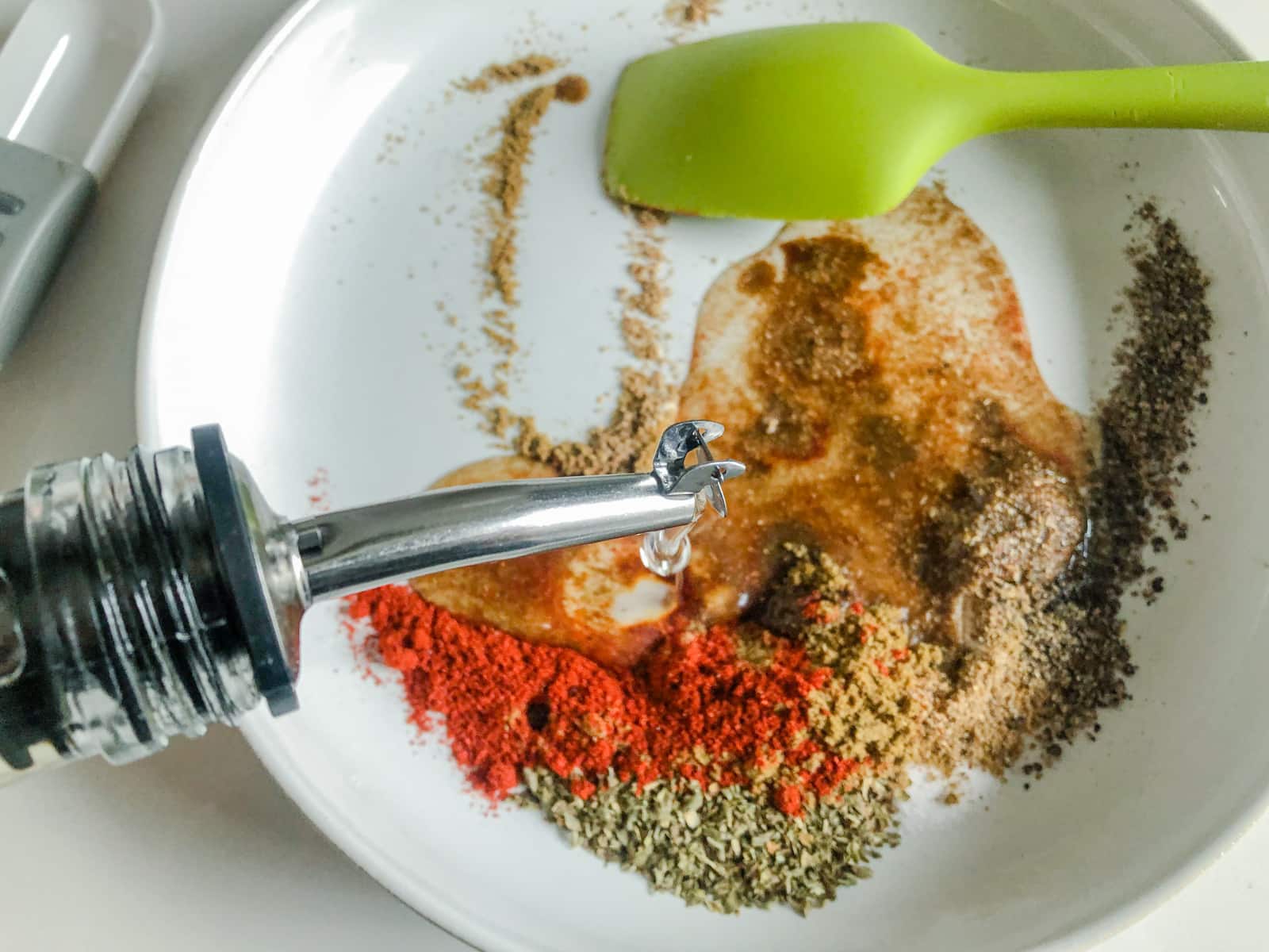 Mixing sunflower oil with spices to make a paste.