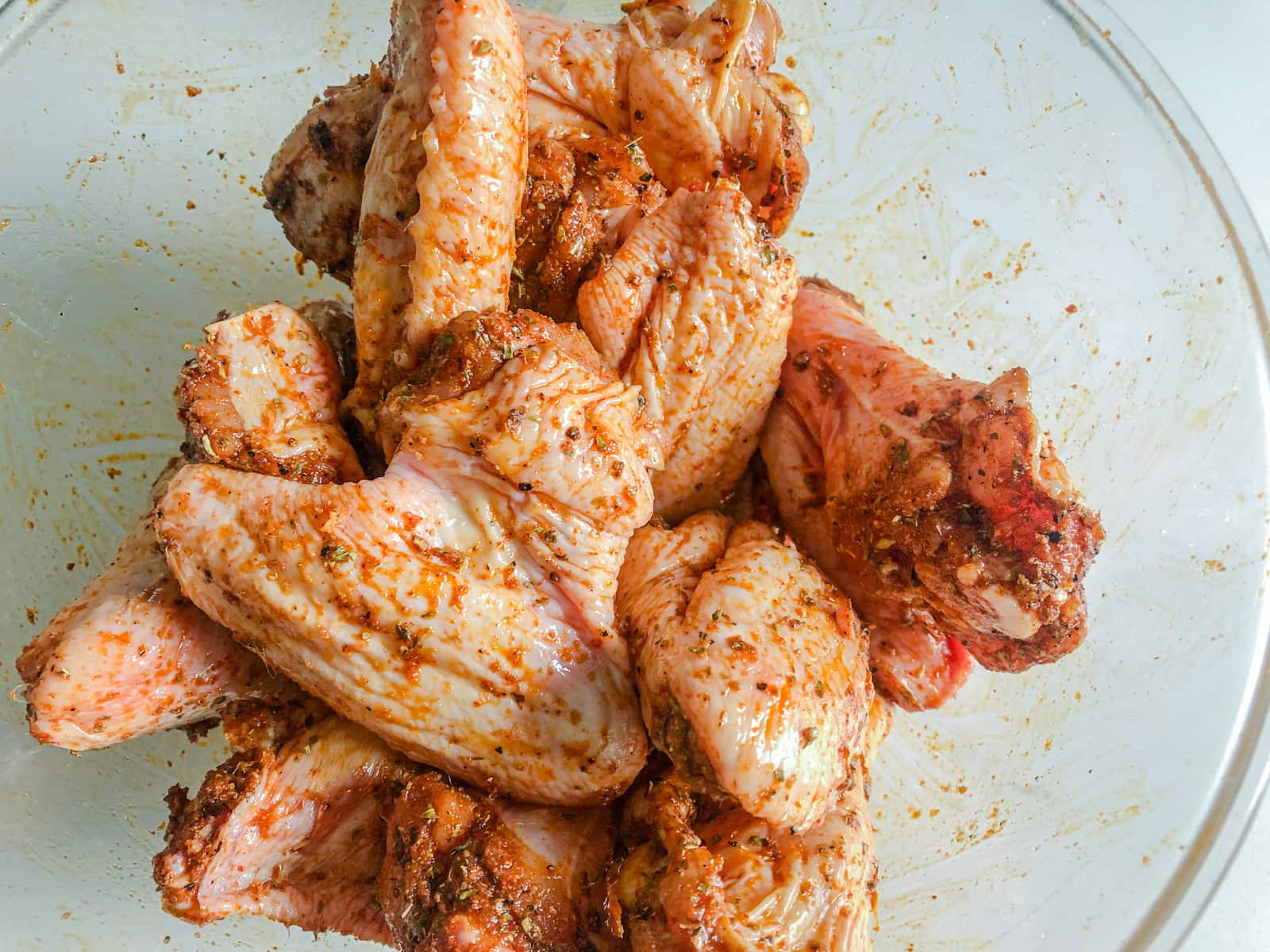 Chicken wings coated with oil and spices.