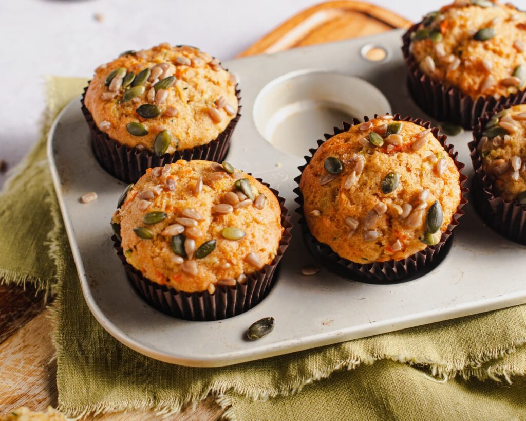 Closeup of carrot muffins in small metal tray.