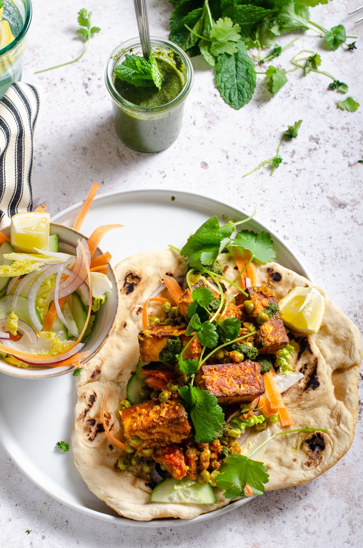 A flatlay of a paneer curry served on flatbread