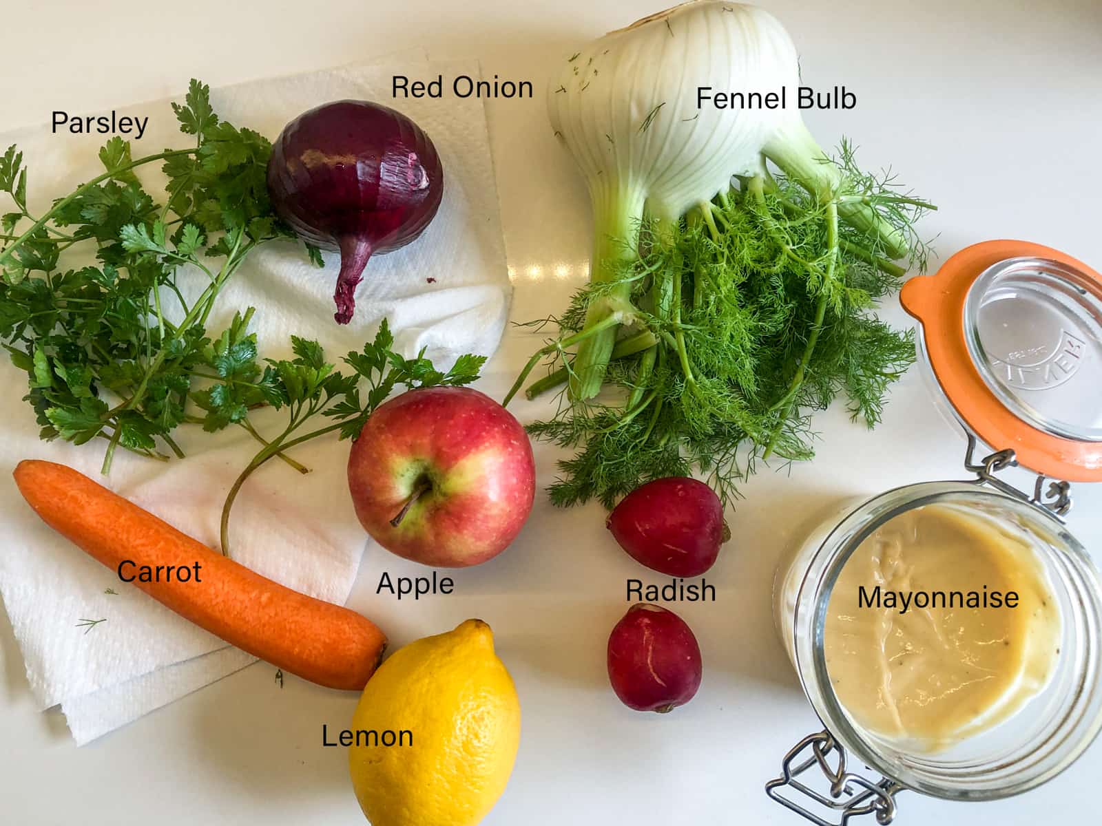 Ingredients laid out and labelled to make a coleslaw.