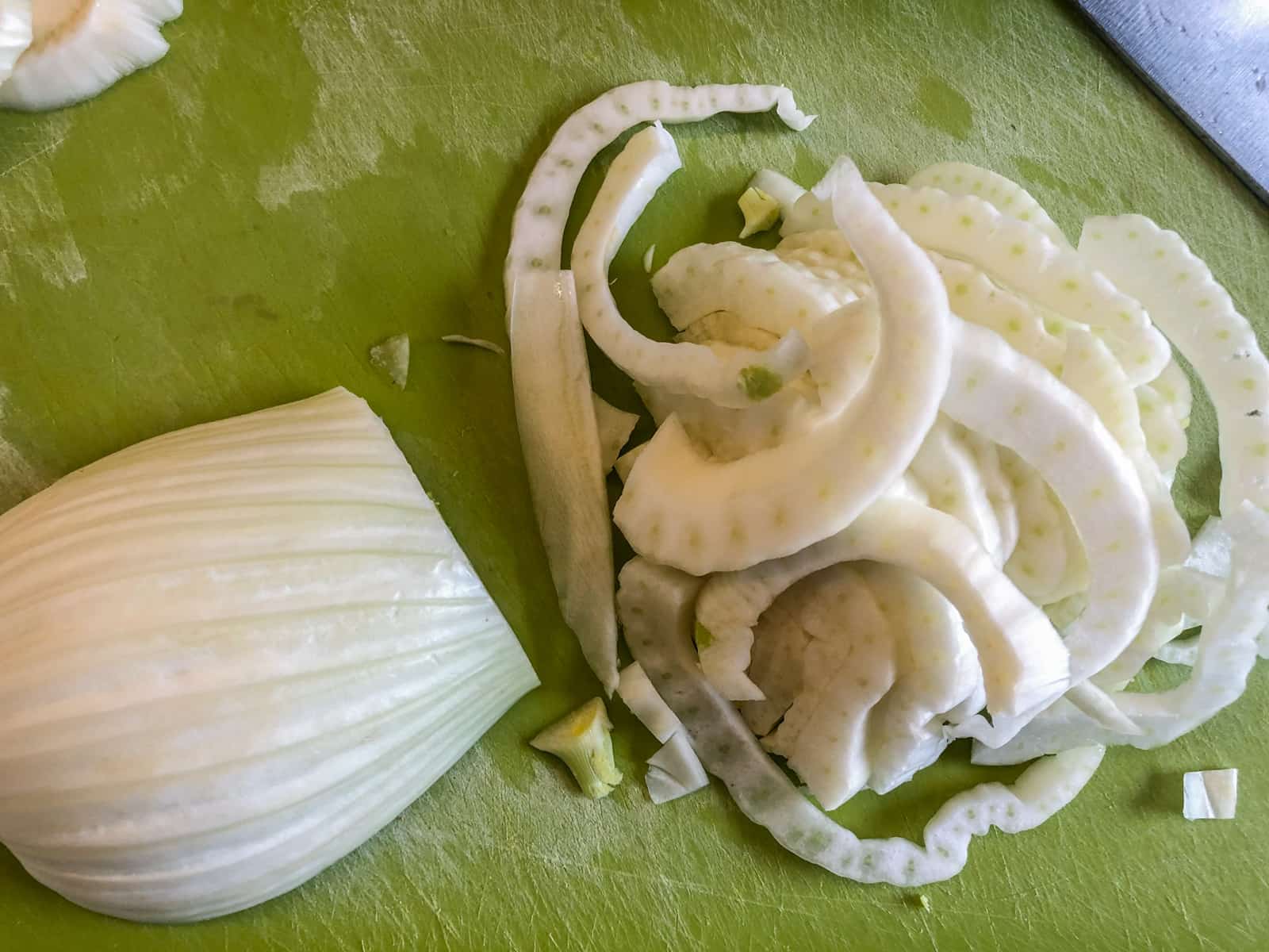 A fennel bulb cut in half and then cut into thin slices.