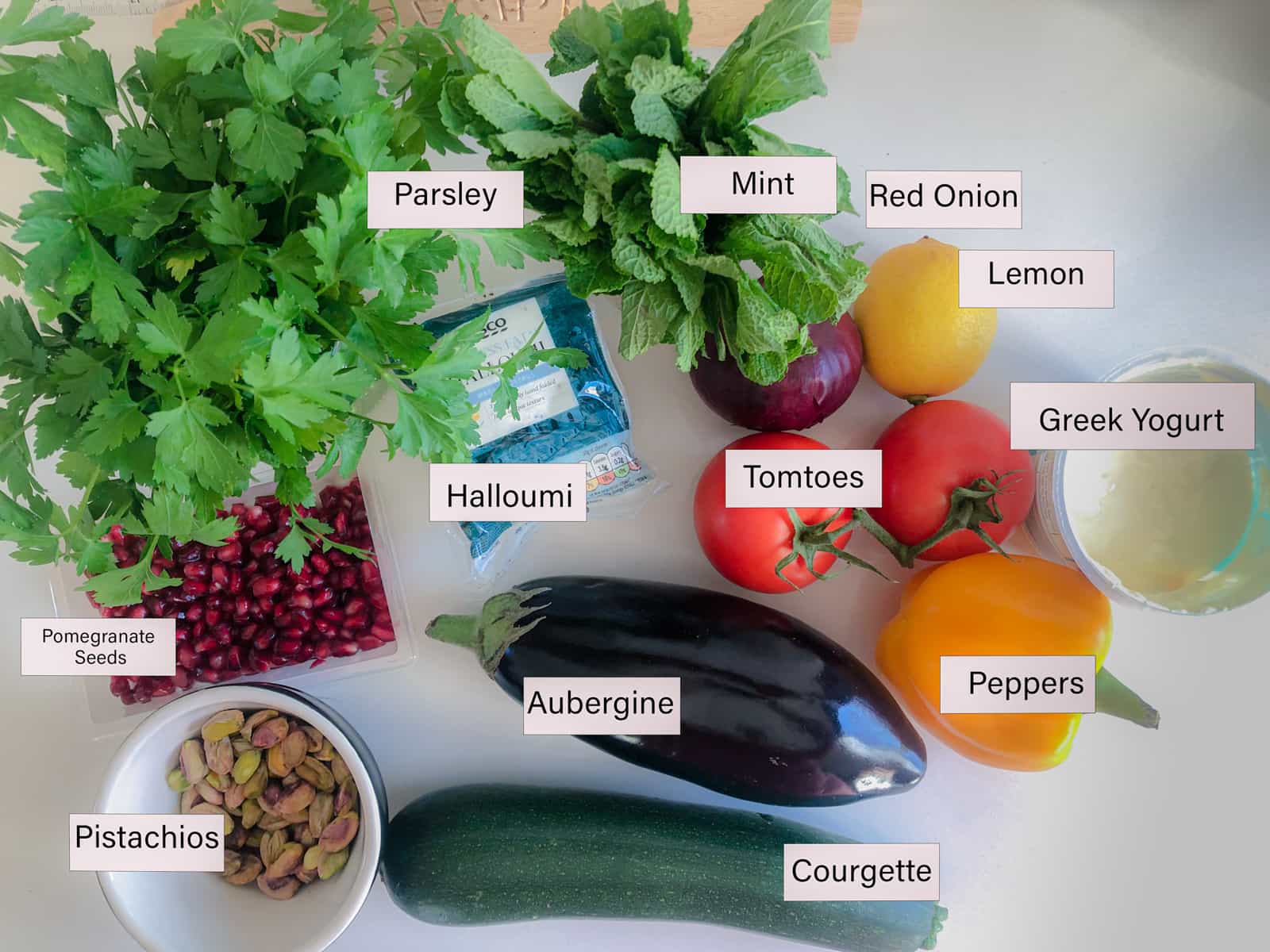Ingredients layered out and labelled for a halloumi and vegetable roasted salad.