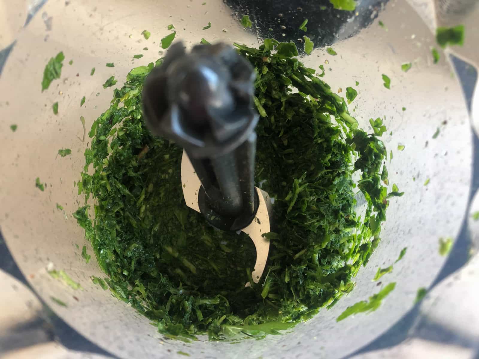 Fresh herbs blitzed in a small hand blender.