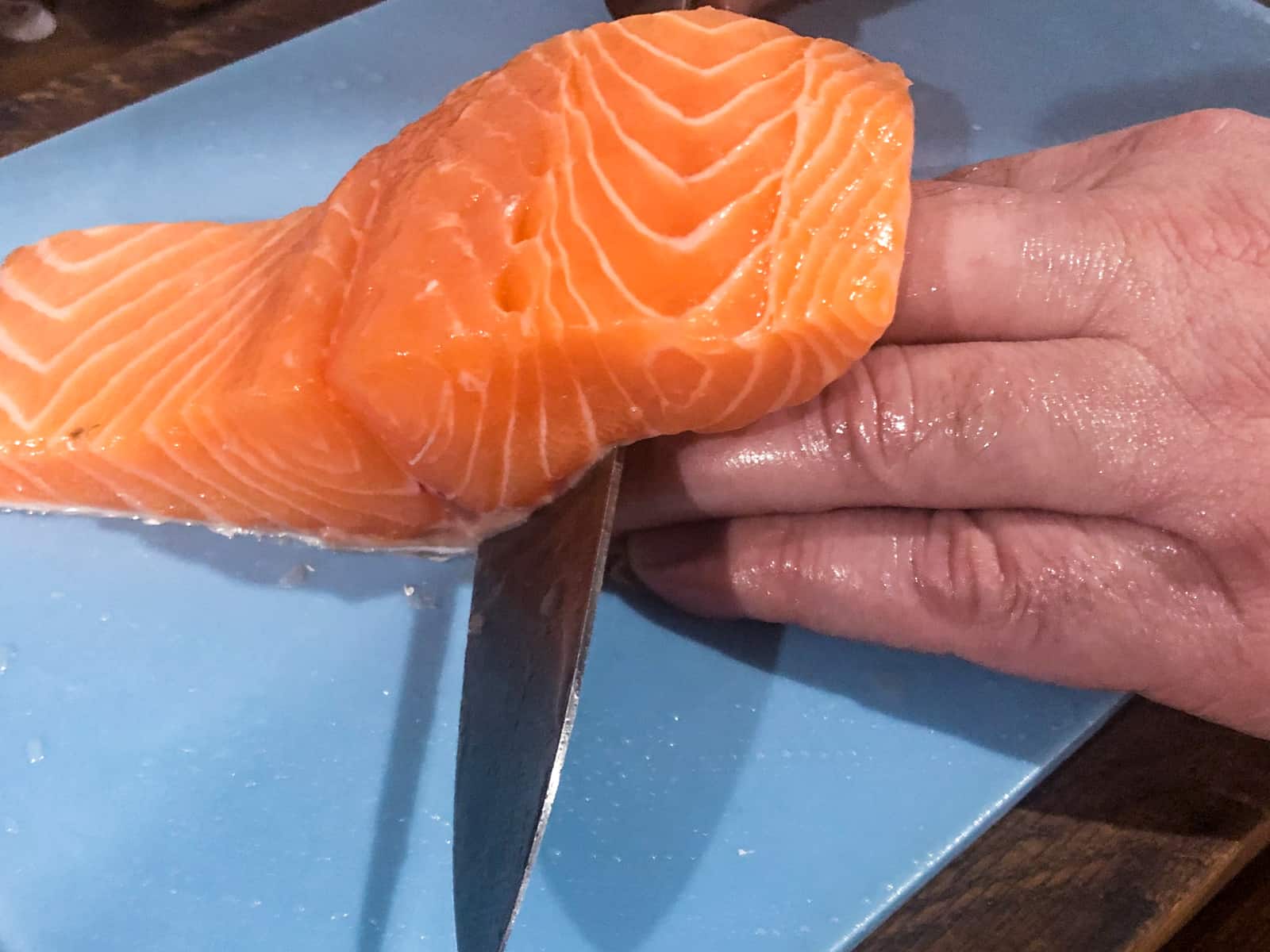 Showing how to remove the skin from salmon fillets.