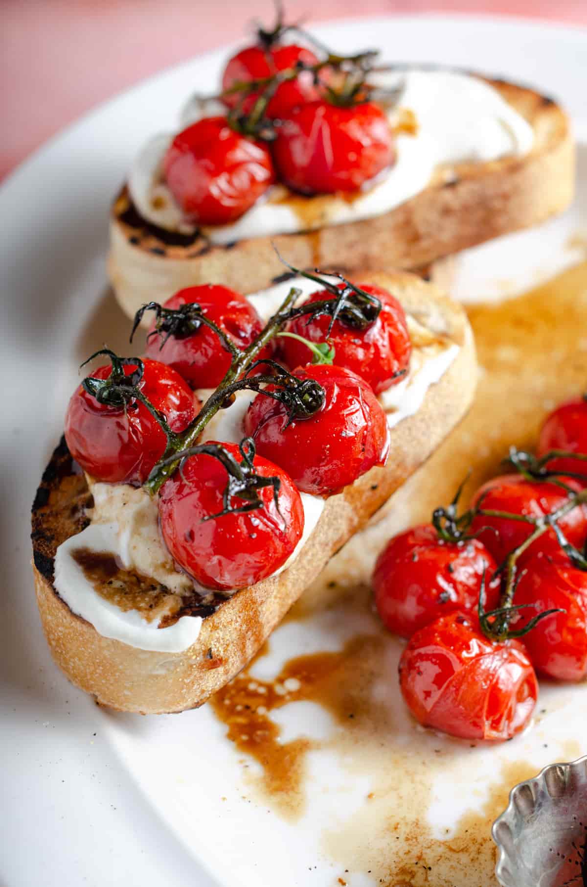 Juicy oven roasted red vine tomatoes glazed with a balsamic vinegar dressing served on whipped feta and toasted sourdough.