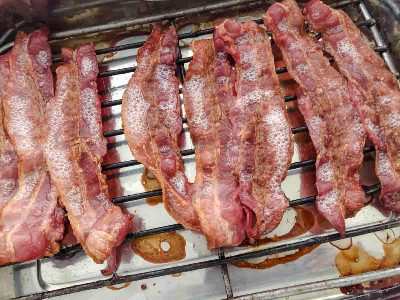 streaky bacon on a tray straight out of the oven.