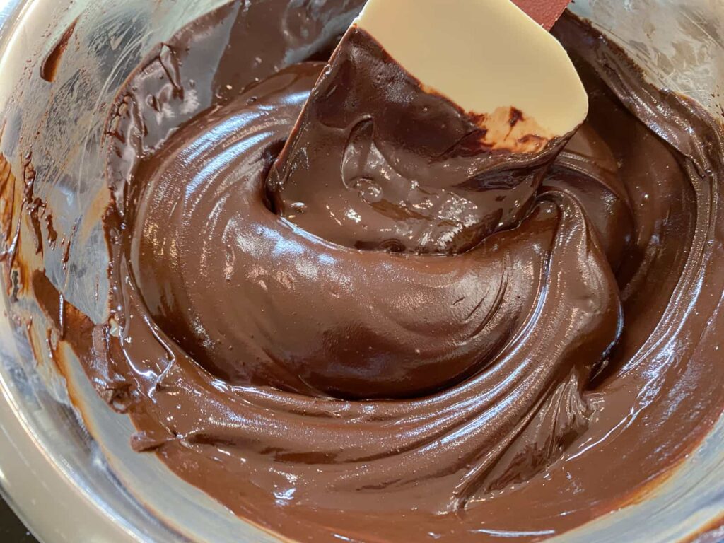 Melted dark chocolate and butter in a glass bowl.