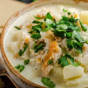 A close up view of traditional cullen skink soup loaded with fresh smoked haddock and cubed potatoes.