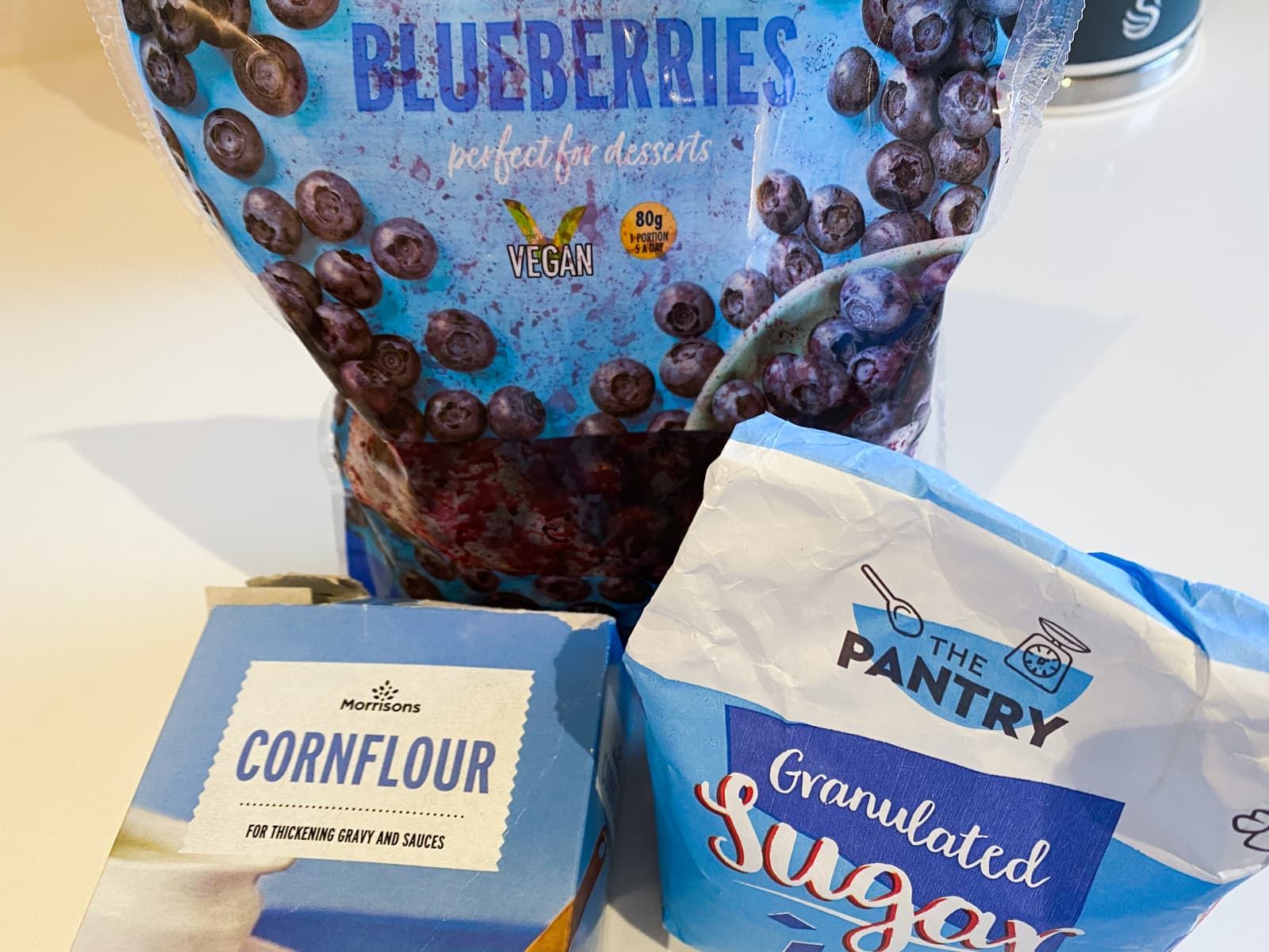 Ingredients to make a blueberry compote, frozen blueberries, sugar and cornflour.