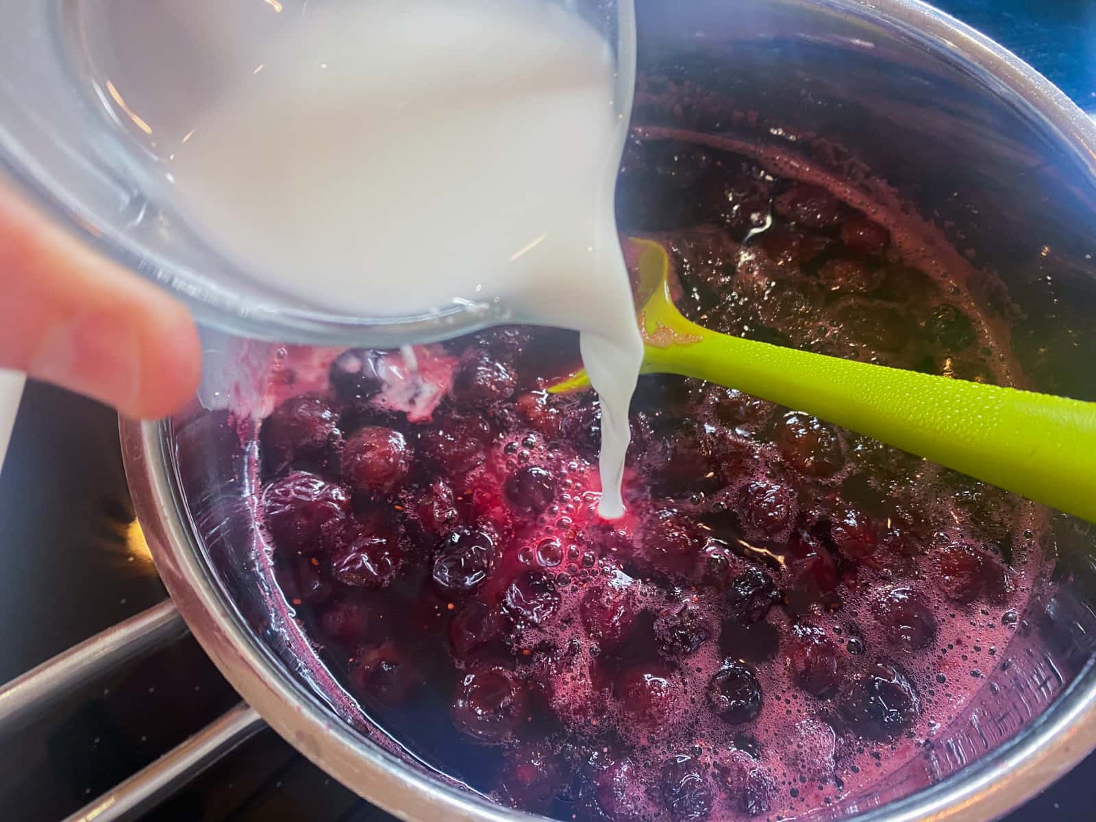 Blueberries and sugar in a small pan, removed from the heat and a mix of cornflour and water added to thicken.