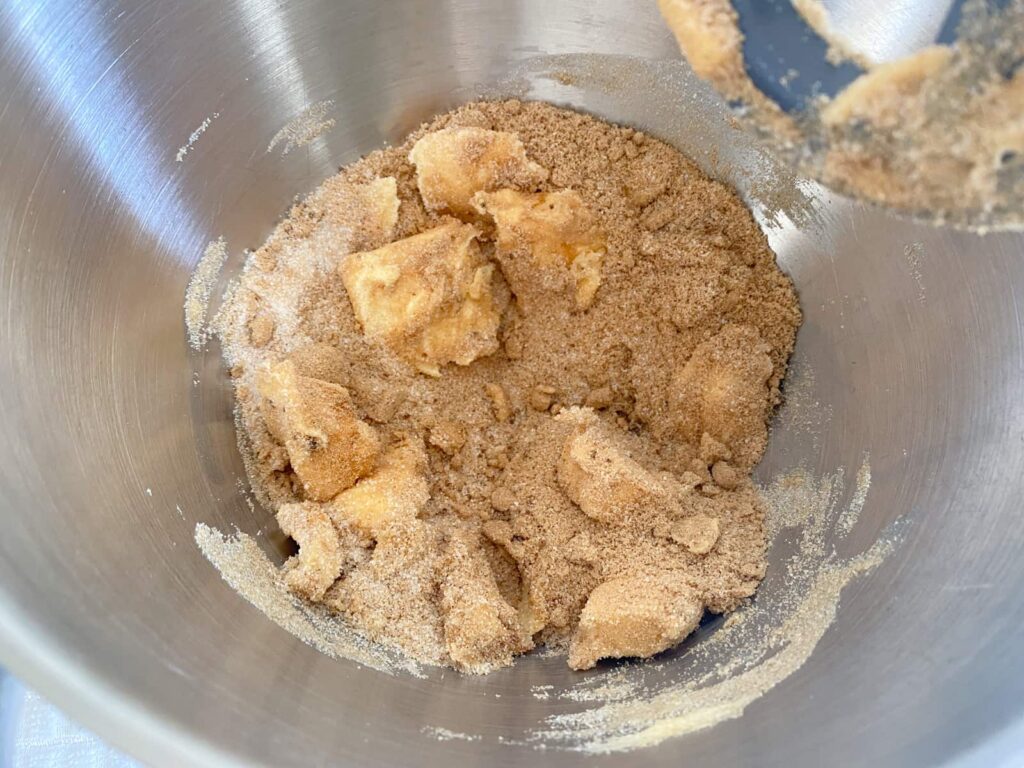 Butter being creamed together with white and brown sugar.