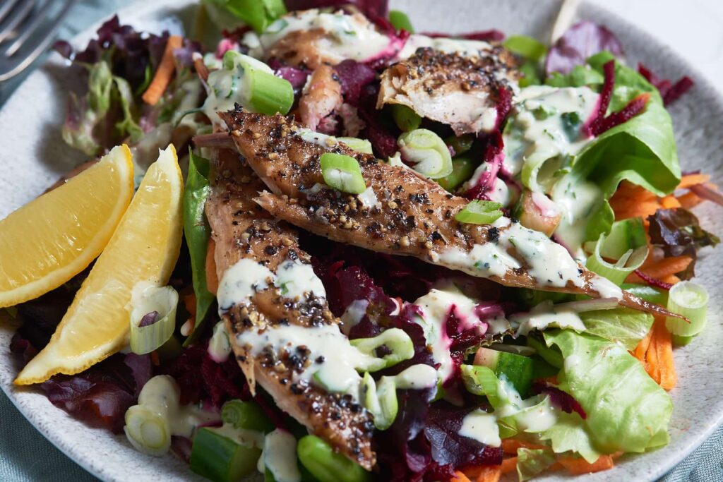 Smoked Mackerel pieces on top of salad leaves, mixed with grated beetroot, carrots and spring onions served with lemon wedges and topped with a creamy horseradish dressing.