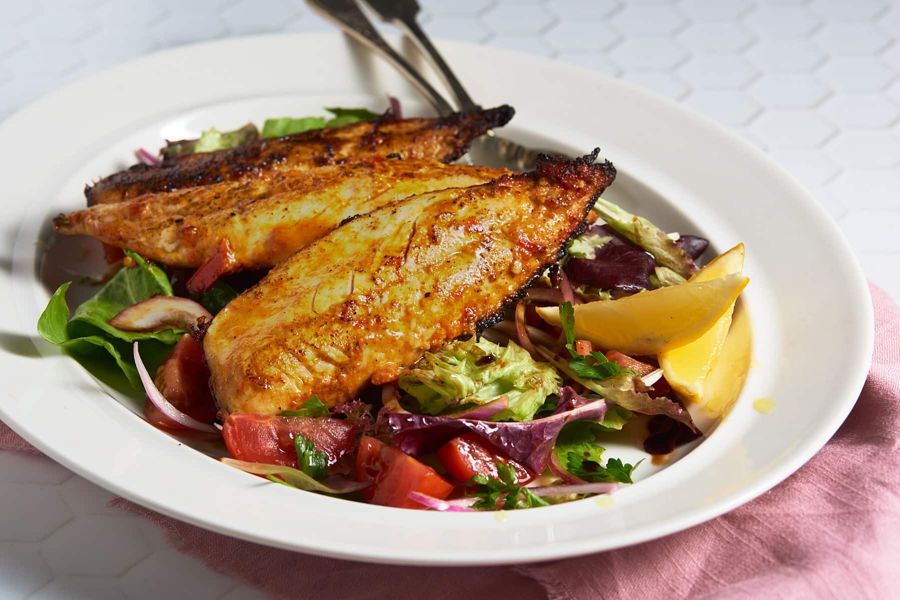 Pan fried mackerel with a devilled marinade and a tomato and red onion salad.