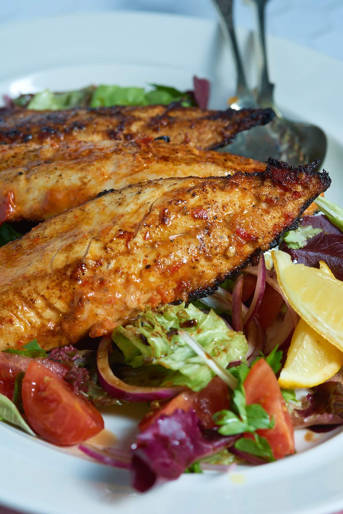 Pan fried mackerel with a devilled marinade and a tomato and red onion salad.
