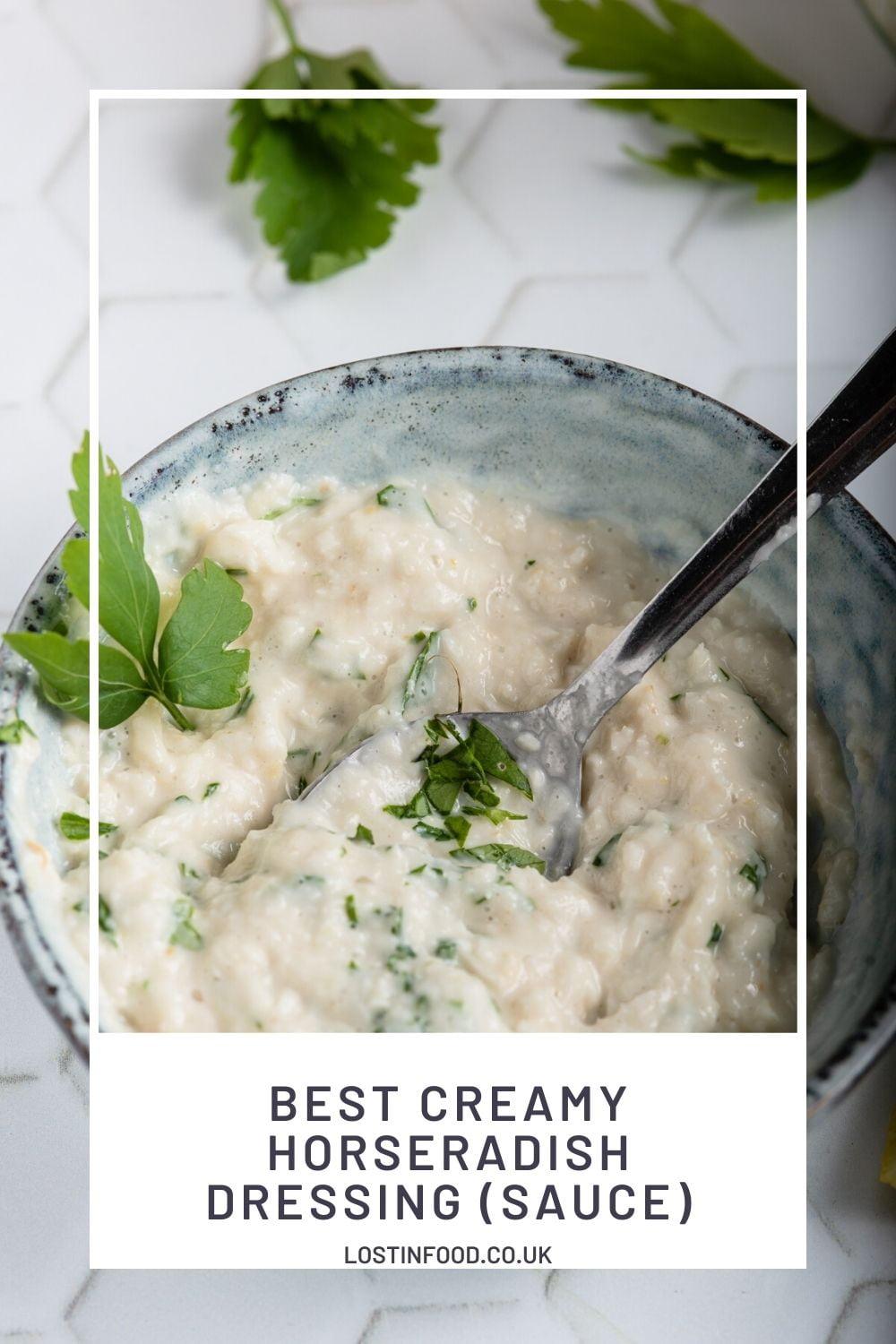 Pinnable image with recipe title and top down, close-up image of blue pottery bowl with creamy horseradish dressing with a garnish of freshly chopped parsley.