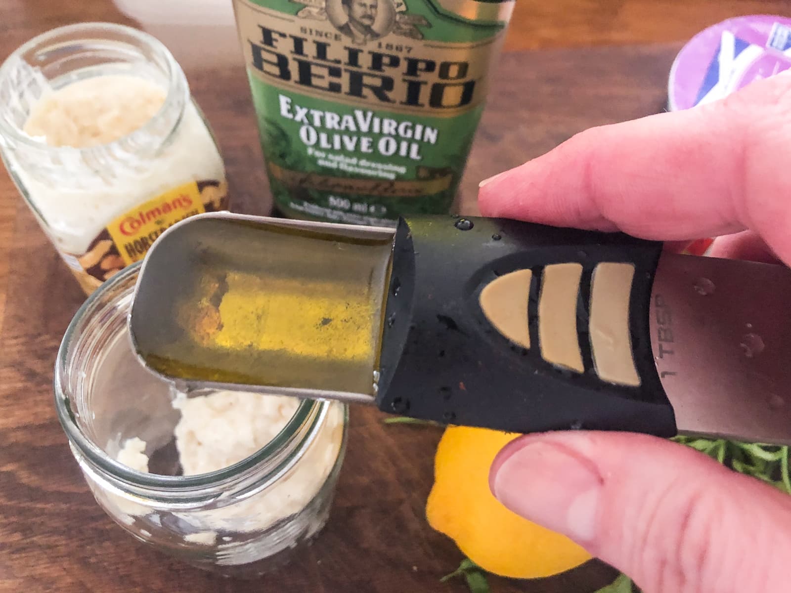 Adding oil to making a dressing.