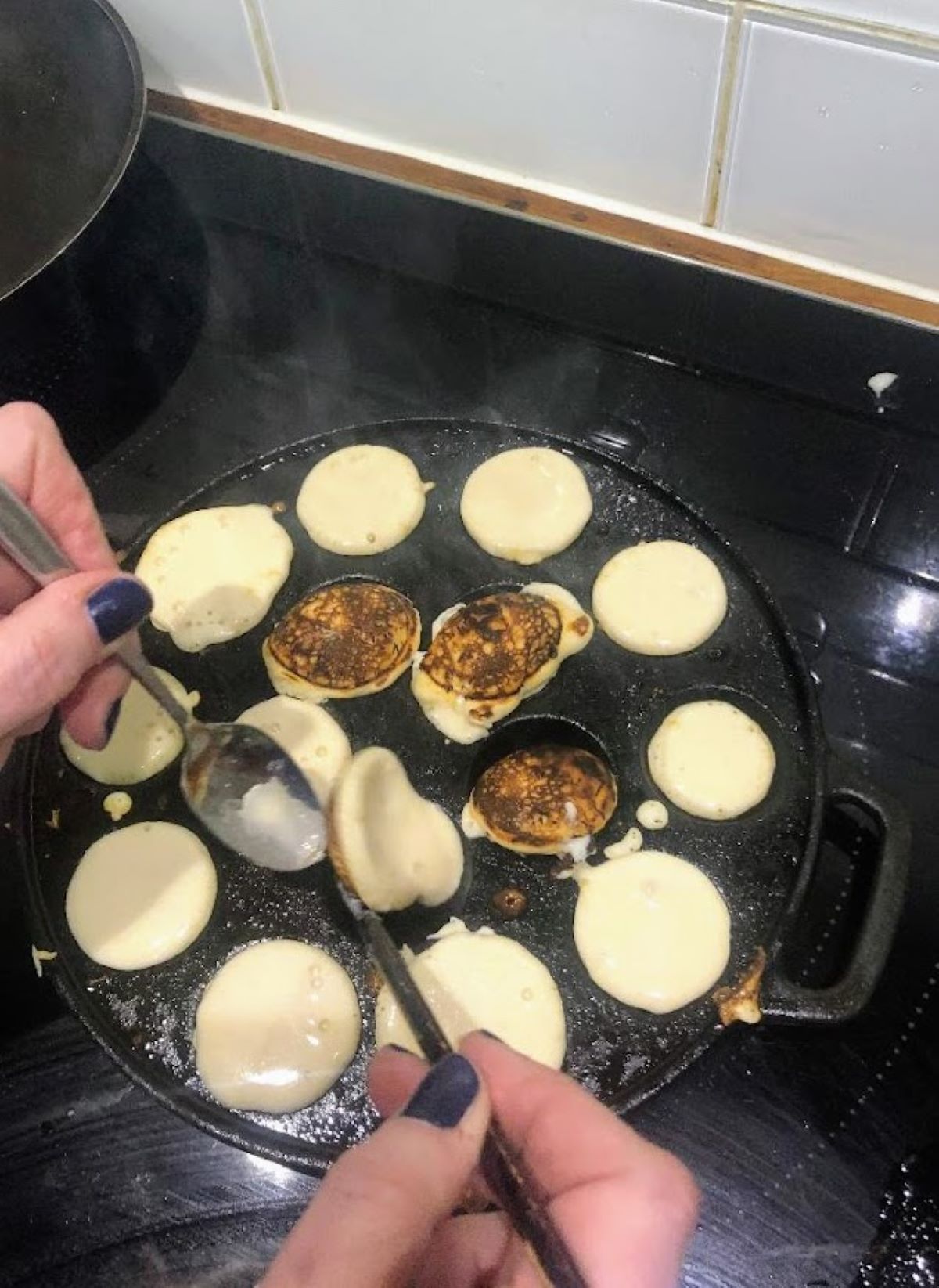 poffertjes being flipped over