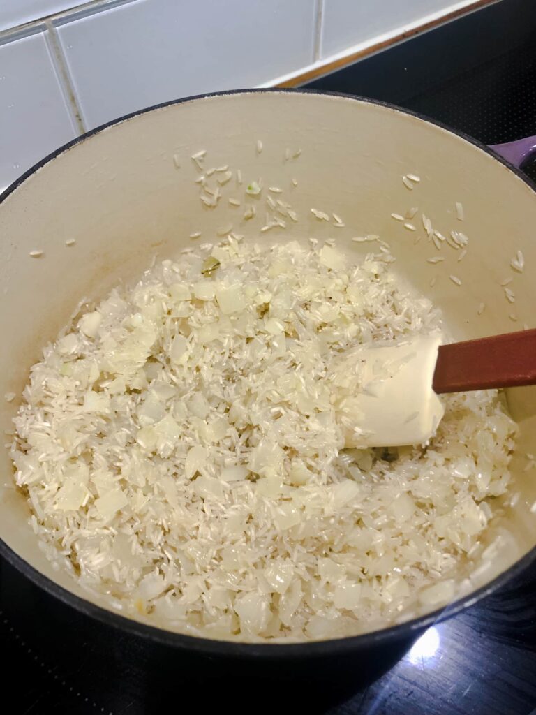 Dutch oven with sauteed onions, garlic and white rice