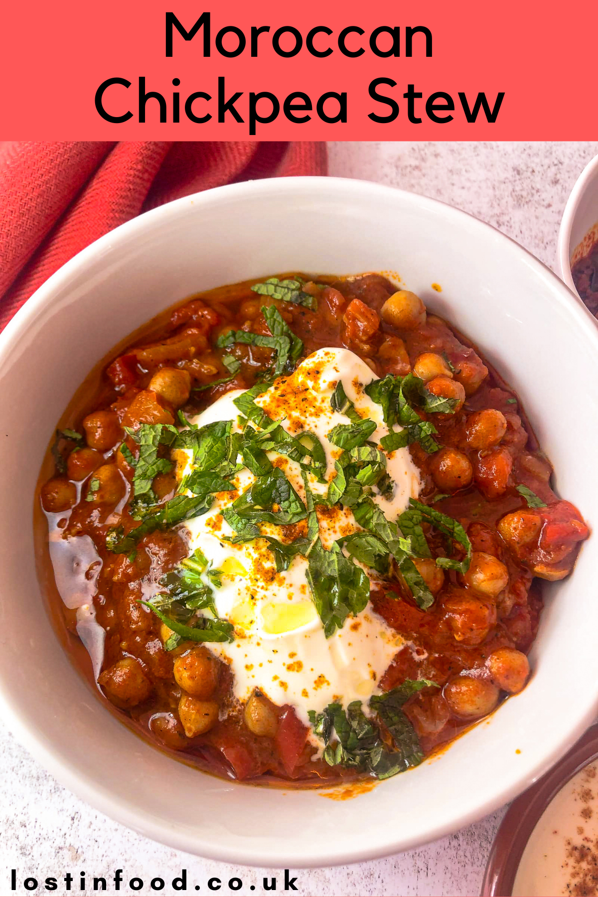 pinnable image with recipe title and white bowl filled with Moroccan chickpea stew topped with a spoon of Greek yogurt, freshly chopped mind and a drizzle of olive oil