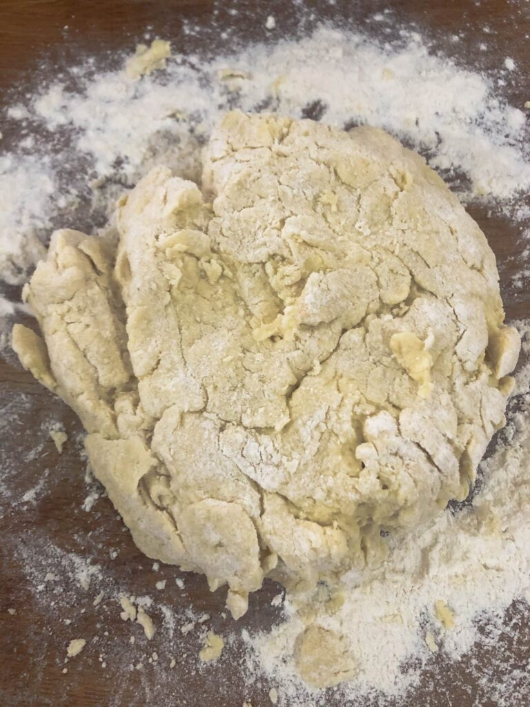 ball of buttermilk scones dough on a floured board