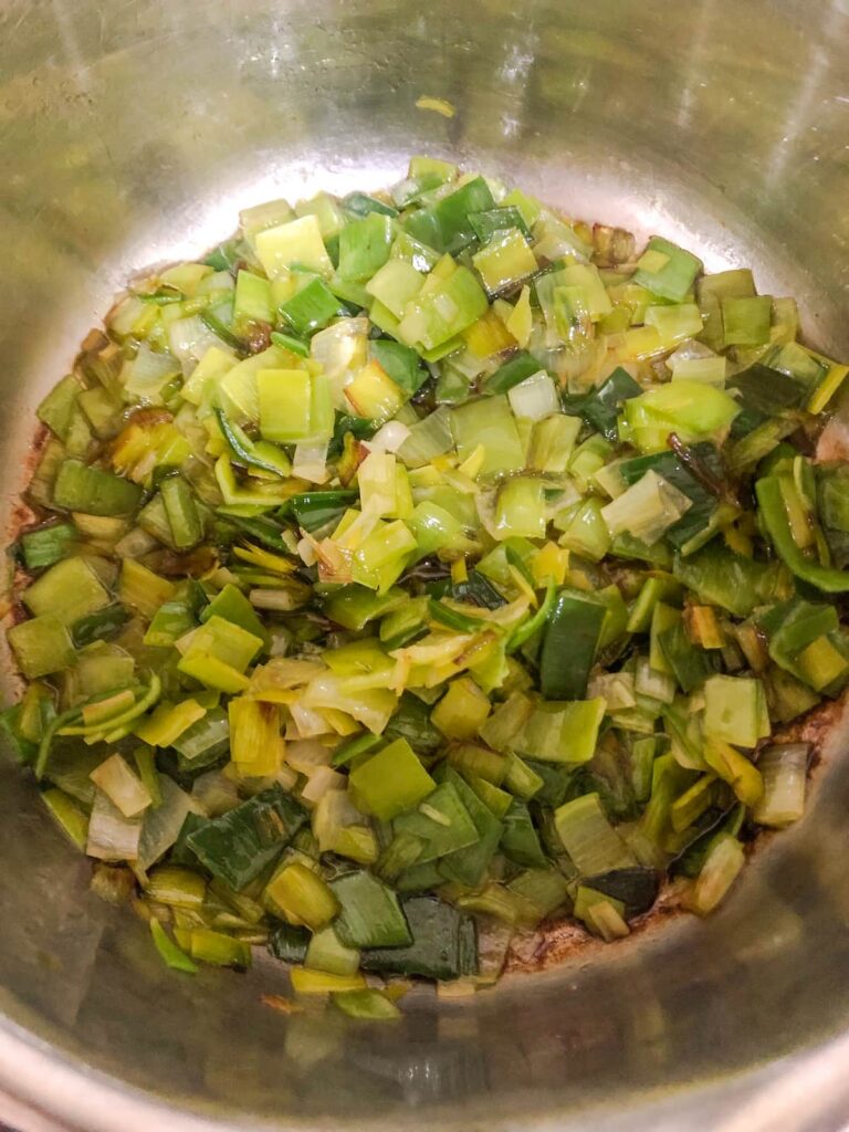 saucepan filled with sliced and sauteed leeks