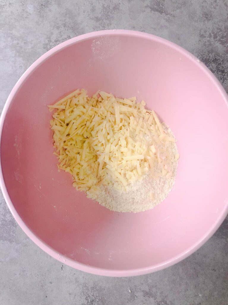 pink bowl with ingredients for cheese scones