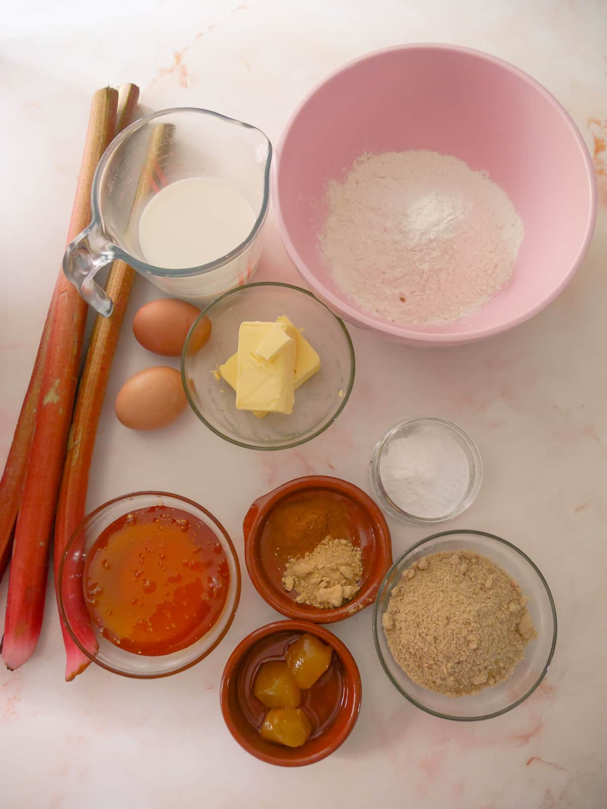 Rhubarb and ginger cake recipe ingredients set into individual bowls.