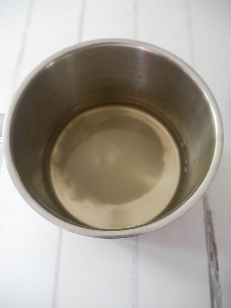 A stainless steel saucepan filled with vinegar, water and sugar.