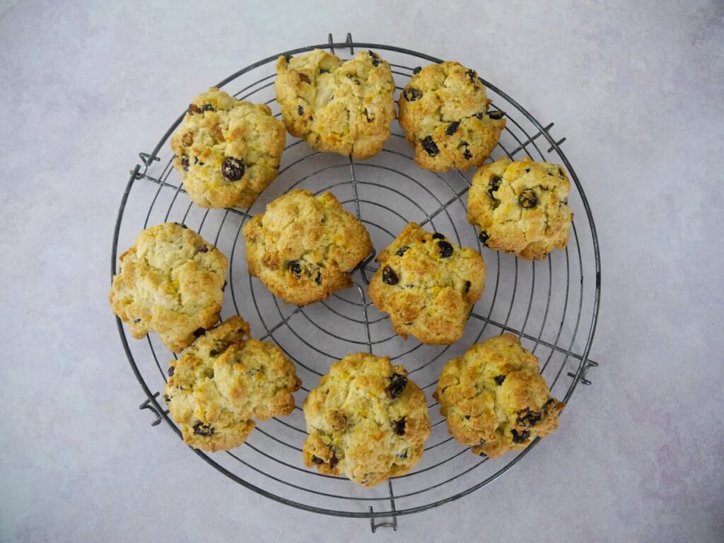 A circular wire rack topped with 10 rock cakes.