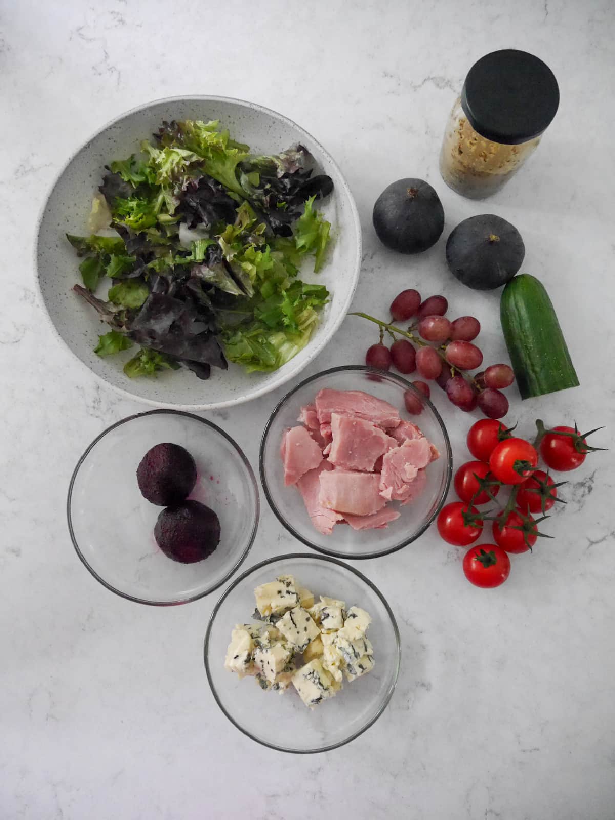 Ham fig and blue cheese salad recipe ingredients set into individual bowls.