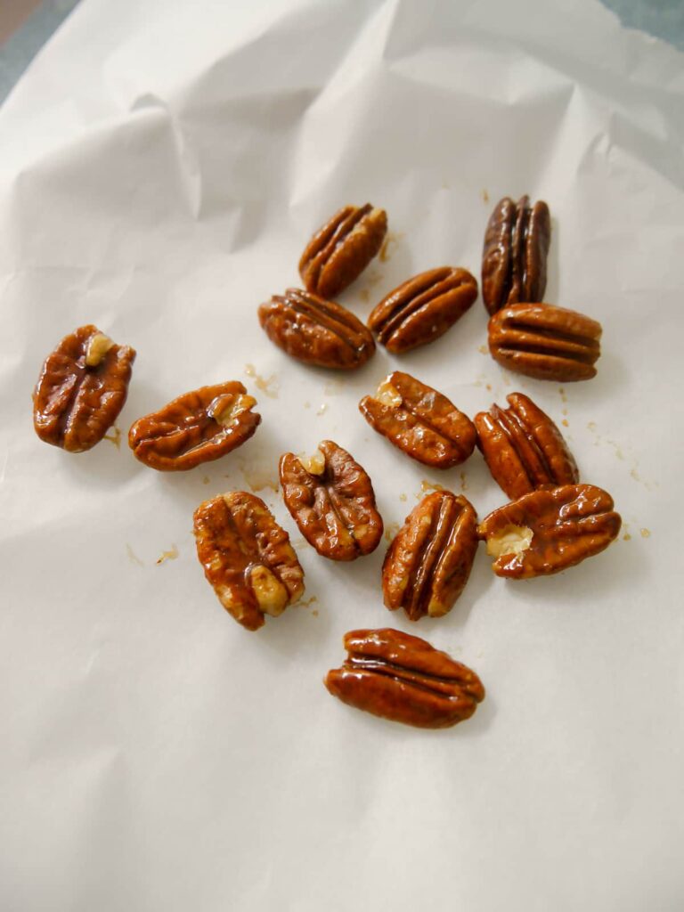 Candied pecans set onto baking paper.