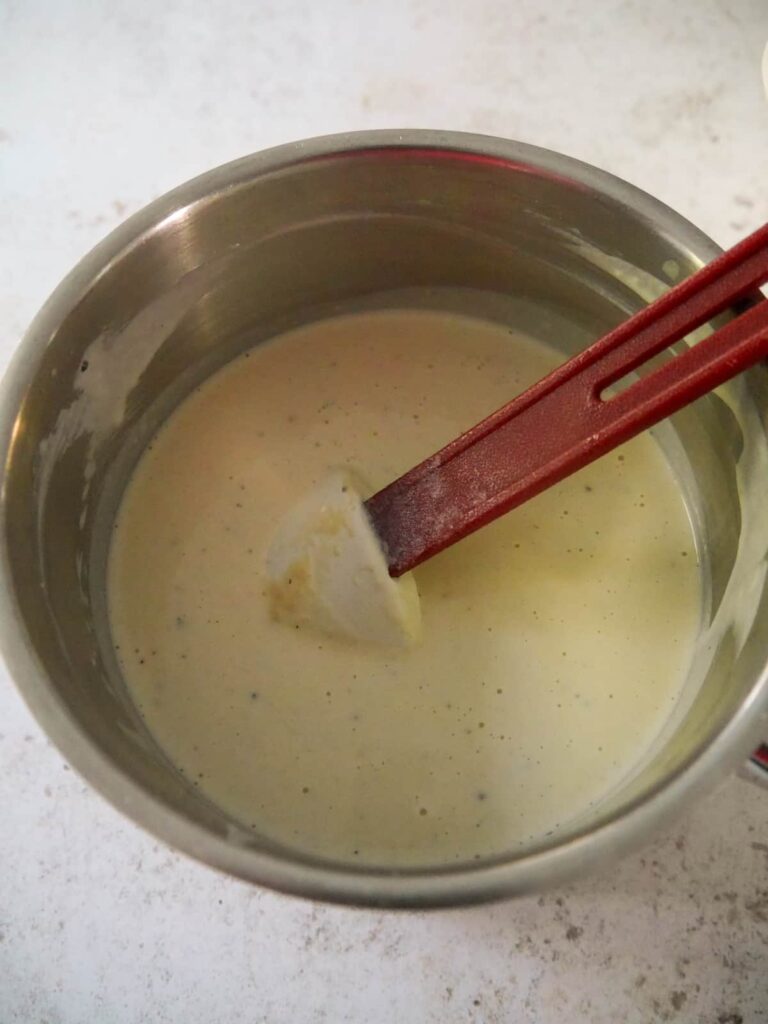 A saucepan of creamy pasta sauce.