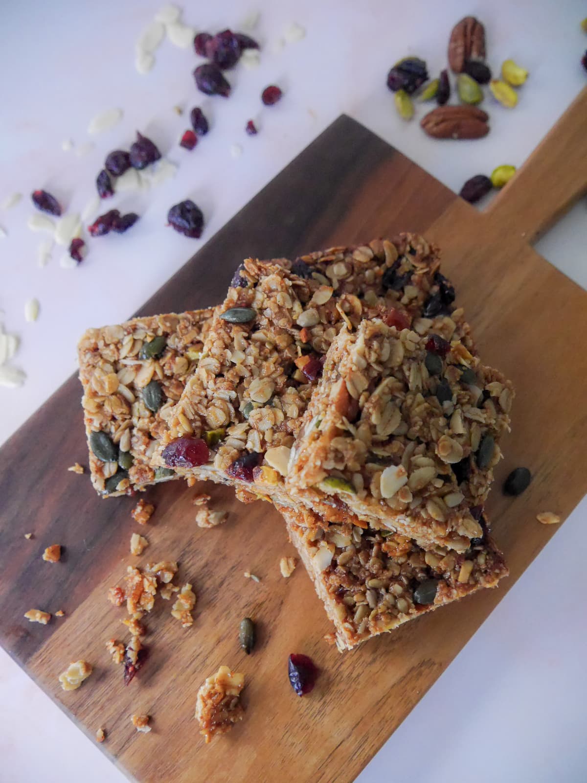 A wooden board topped with 5 slices of Christmas spiced flapjacks.