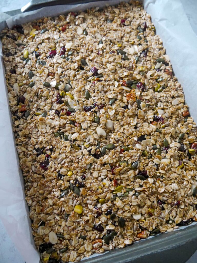 Christmas spiced flapjack ingredients pressed into an oven proof tray lined with baking parchment.