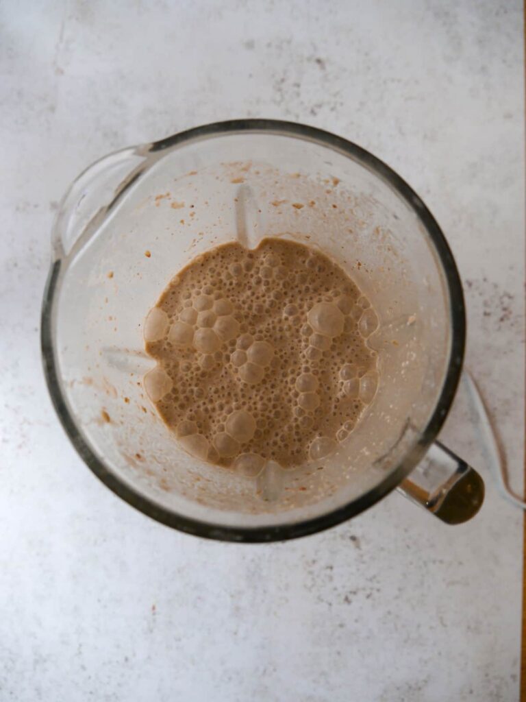Chocolate peanut butter smoothie blitzed in a blender jug.