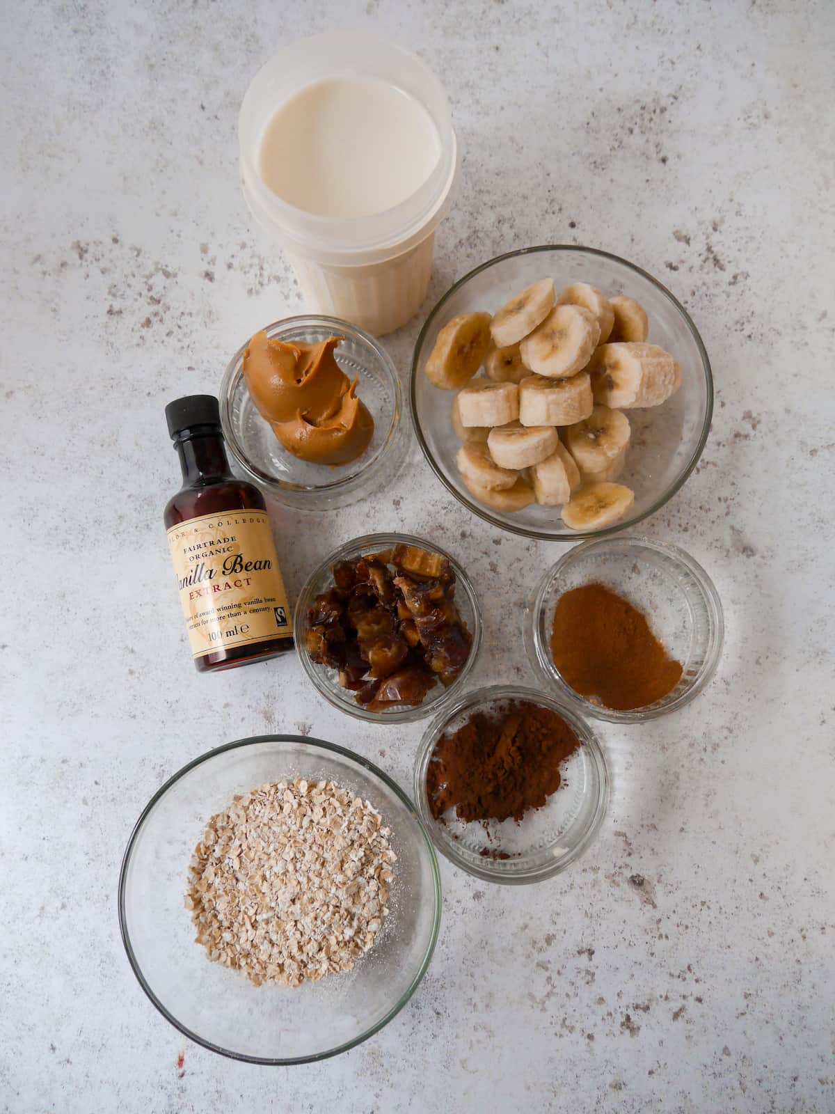 Chocolate peanut butter smoothie ingredients set out in individual bowls.