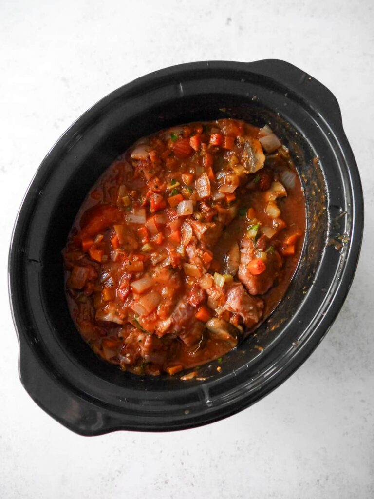 A slow cooked bowl filled with Italian beef ragu ingredients.