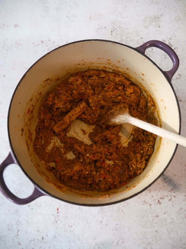 Dutch oven with beef rendang sauteed paste with added dry spices.