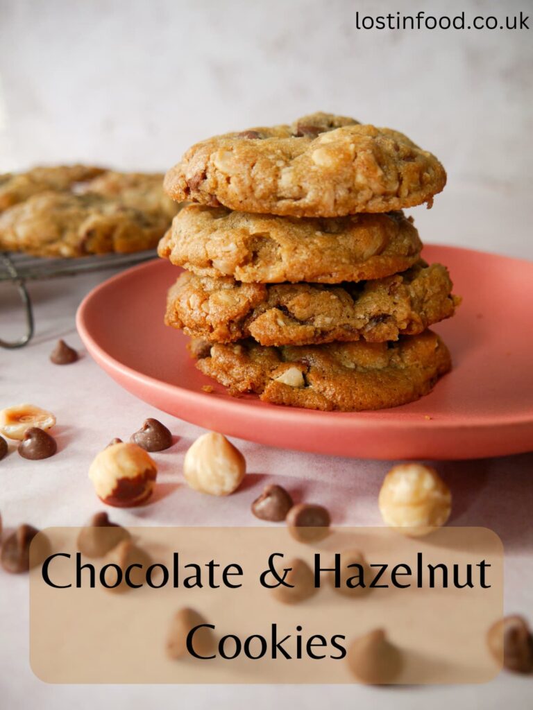 Pinnable image with recipe title and a plate piled with chocolate and hazelnut cookies.