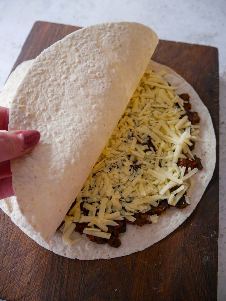 2 flour tortillas with a filling of chunky beef chilli topped with grated cheddar cheese.