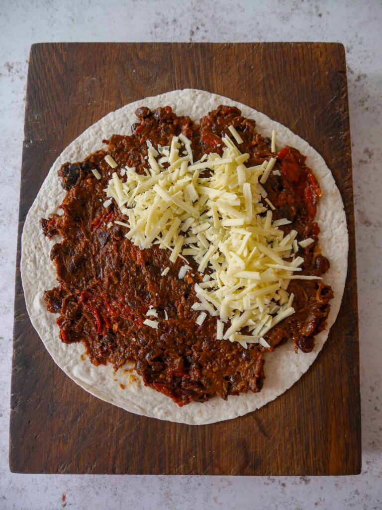 Flour tortillas topped with chunky beef chilli and grated cheddar cheese.