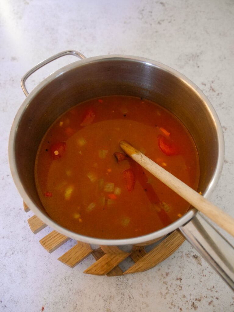 A large saucepan filled with lentil soup.