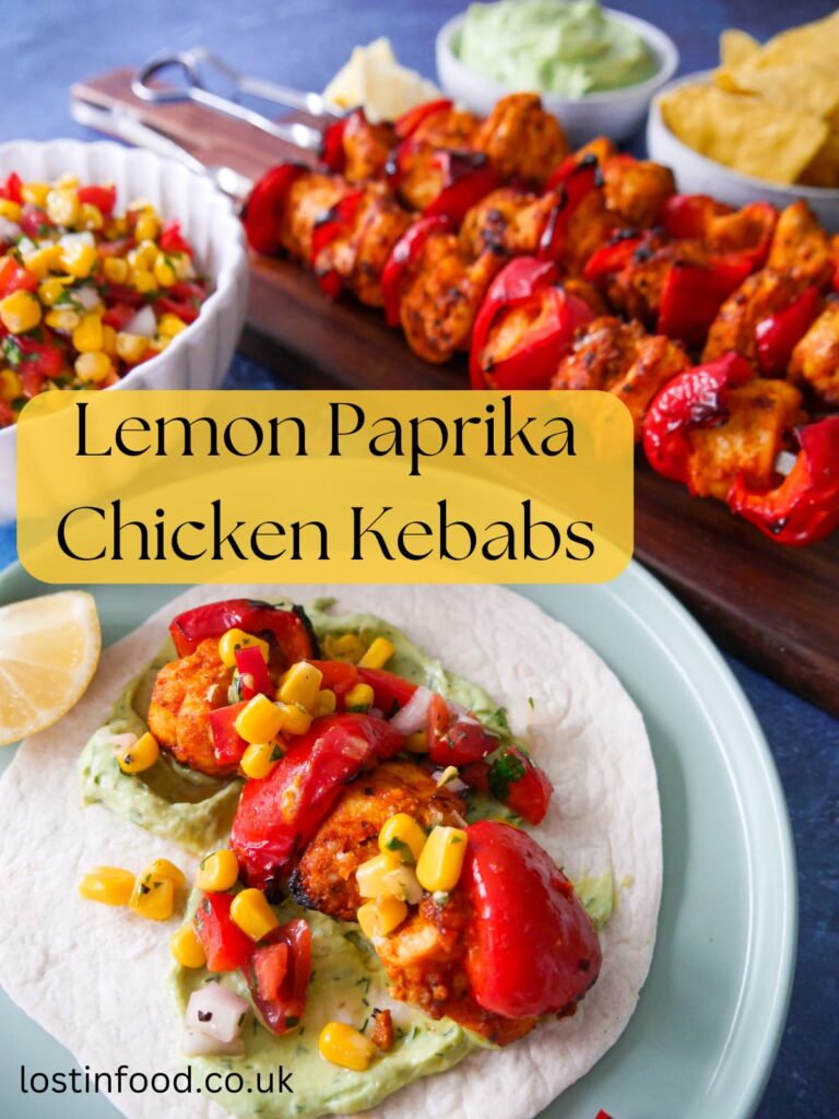 Pinnable image with recipe title and a board with lemon paprika chicken kebabs, with a plate of chicken taco topped with corn salsa.