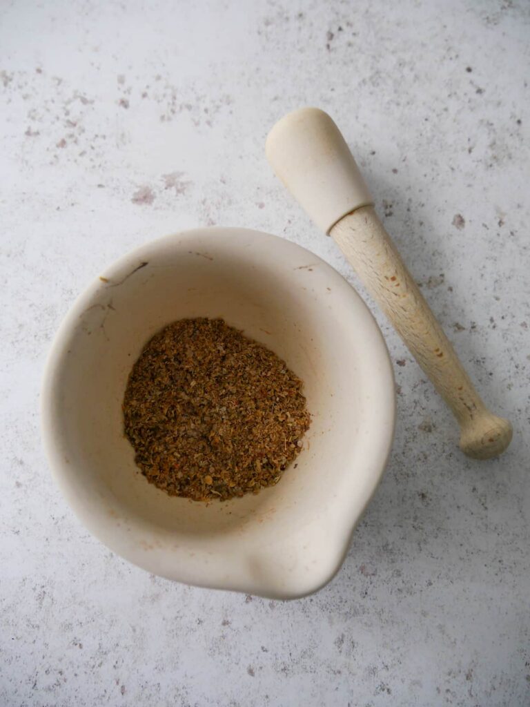 A pentle and mortar with ground dry spices.