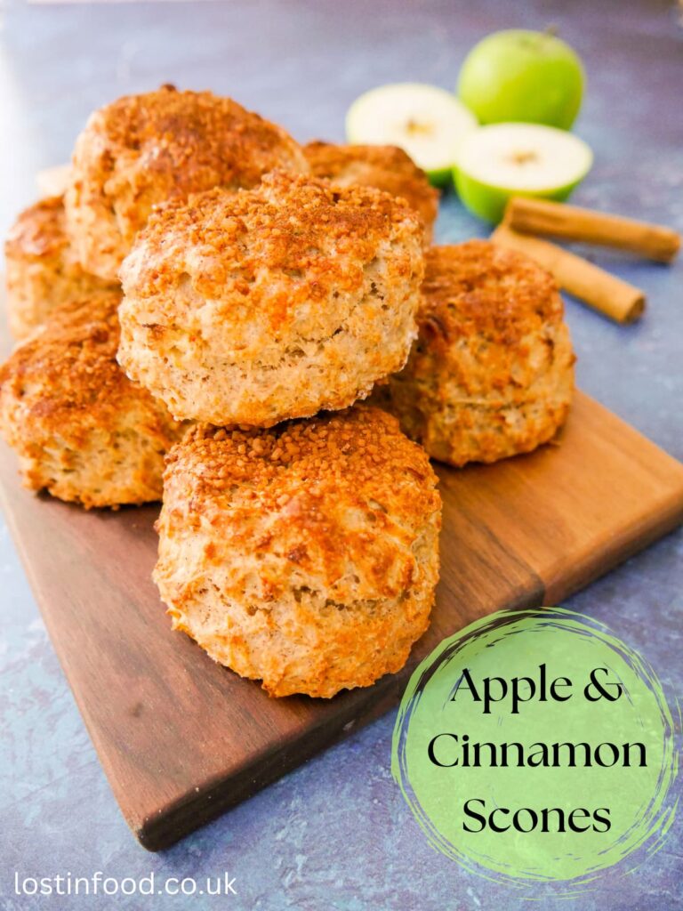 A pinnable image with recipe title and apple and cinnamon scones set on a wooden board.